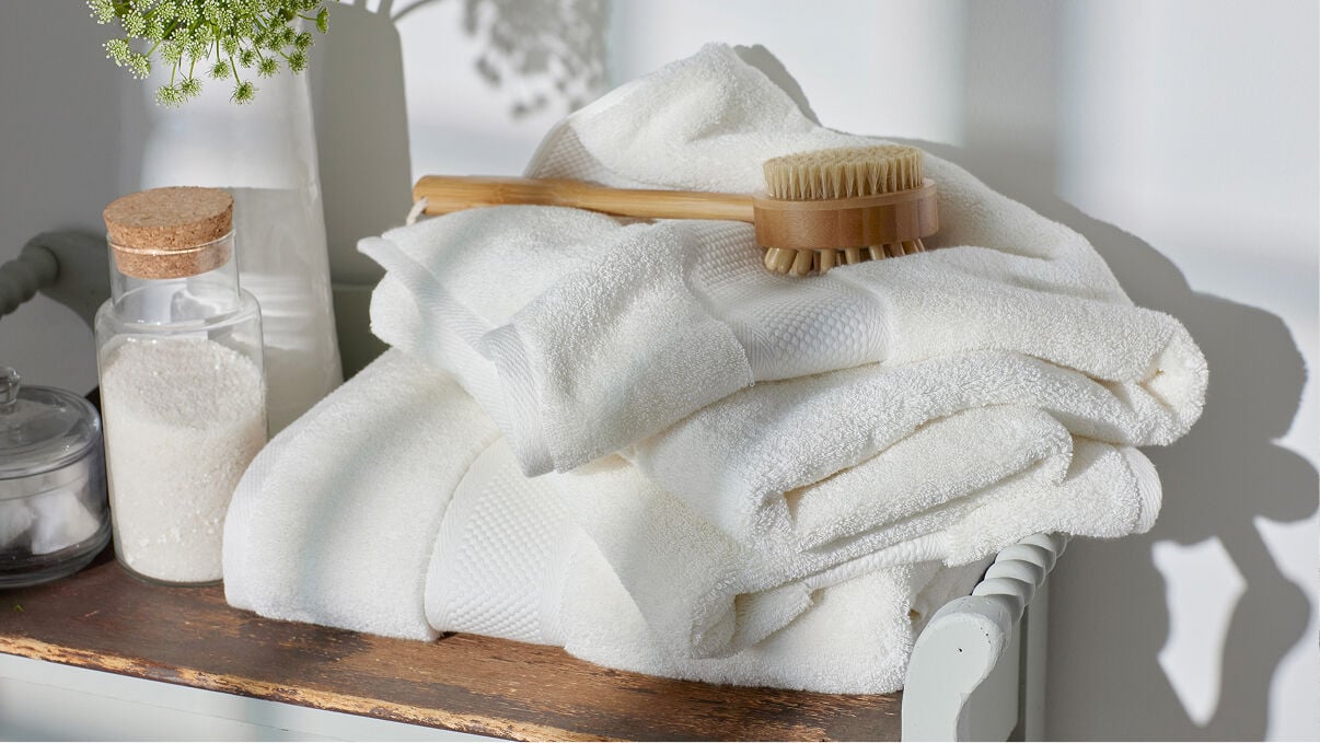 Image of white towels and a bath brush